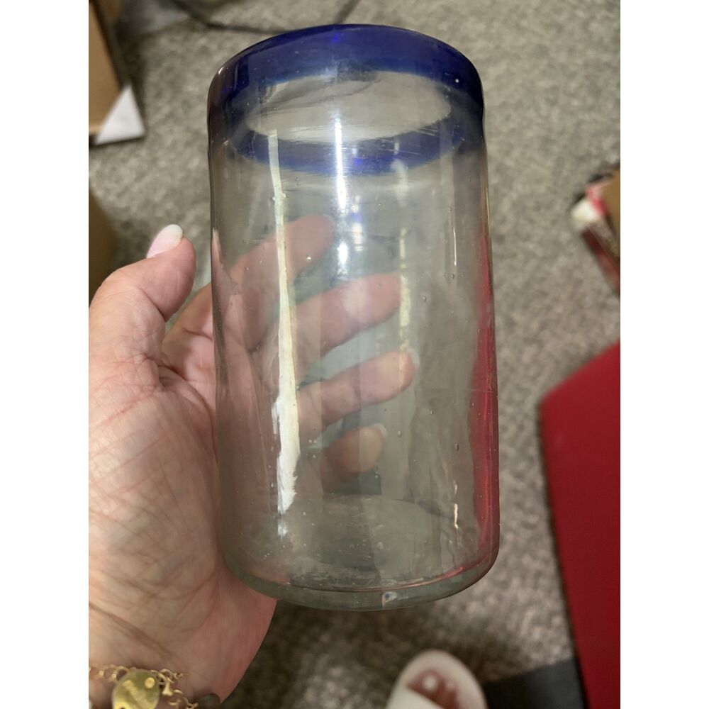 9- handblown heavy glasses with  blue rim. bubbles throughout